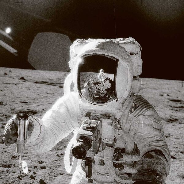 Astronaut on the moon holding a camera, captured in a LED Box Frame design.