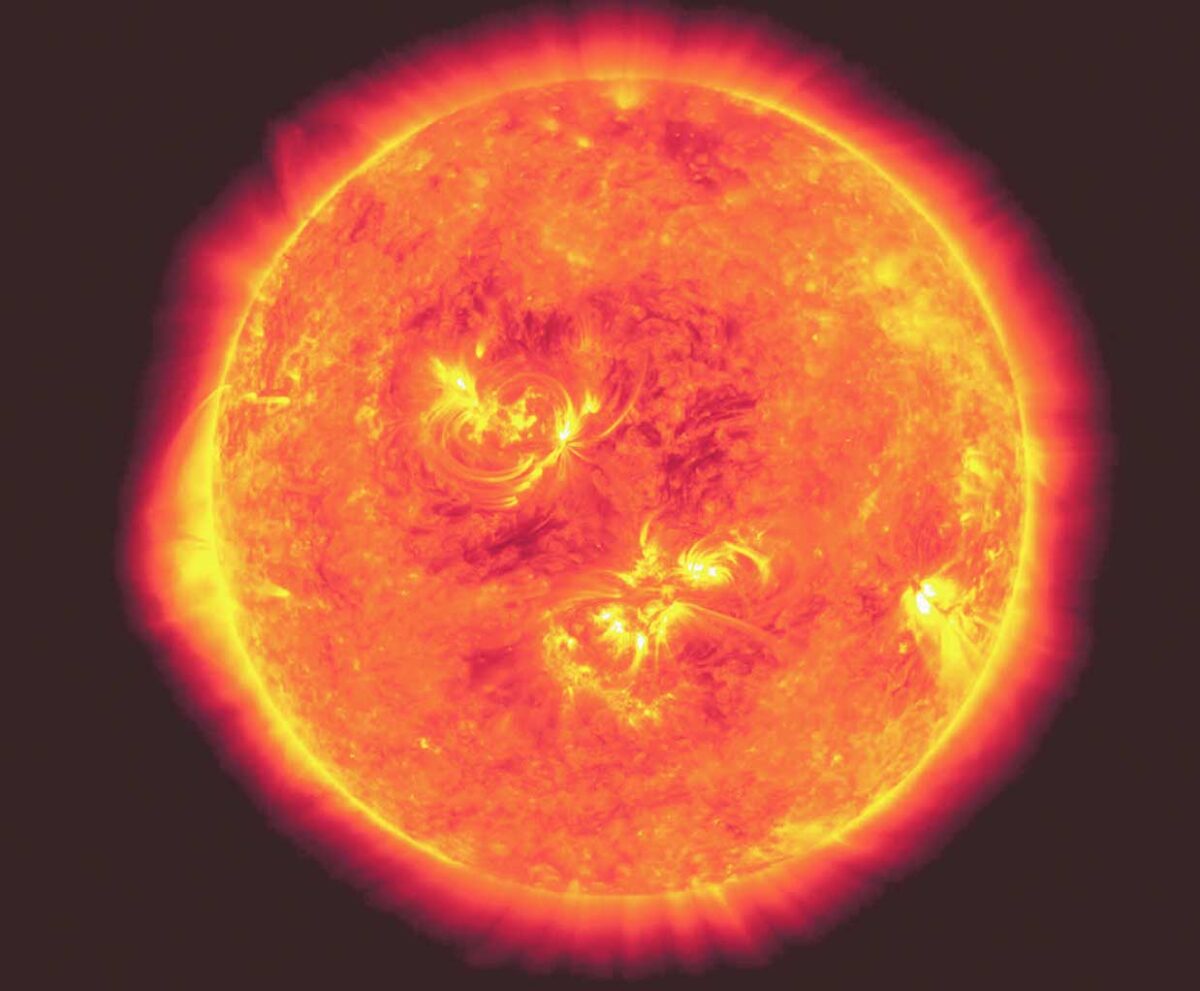 A close-up of the blazing sun in vibrant oranges, yellows, and reds, showcasing solar flares and plasma waves radiating from its surface.