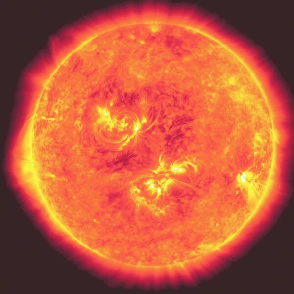 A close-up of the blazing sun in vibrant oranges, yellows, and reds, showcasing solar flares and plasma waves radiating from its surface.