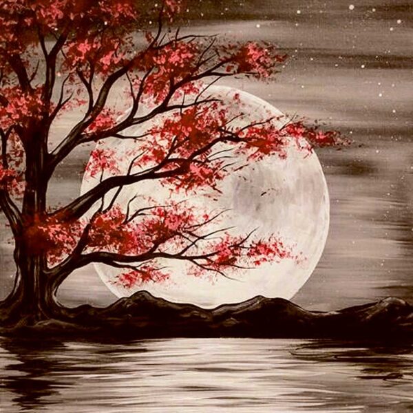 Cherry blossom tree with pink leaves in front of a glowing full moon reflected on a lake