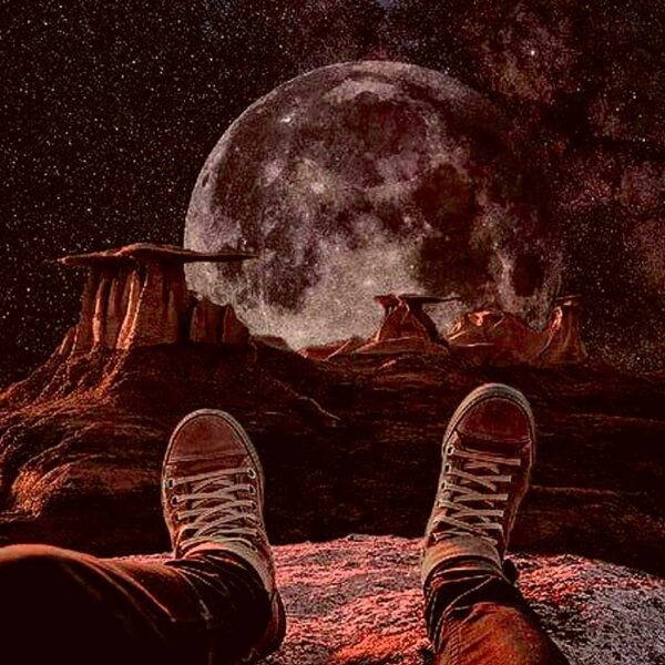 A spaceman sitting on a rocky terrain with a large moon looming in the background, perfect for an LED Box Frame display.