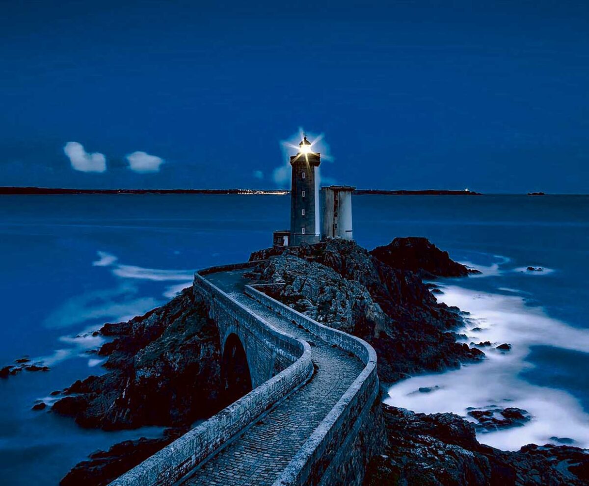 Coastal lighthouse with light beam, illuminated in an energy-efficient LED Box Frame, perfect for home and office decor.