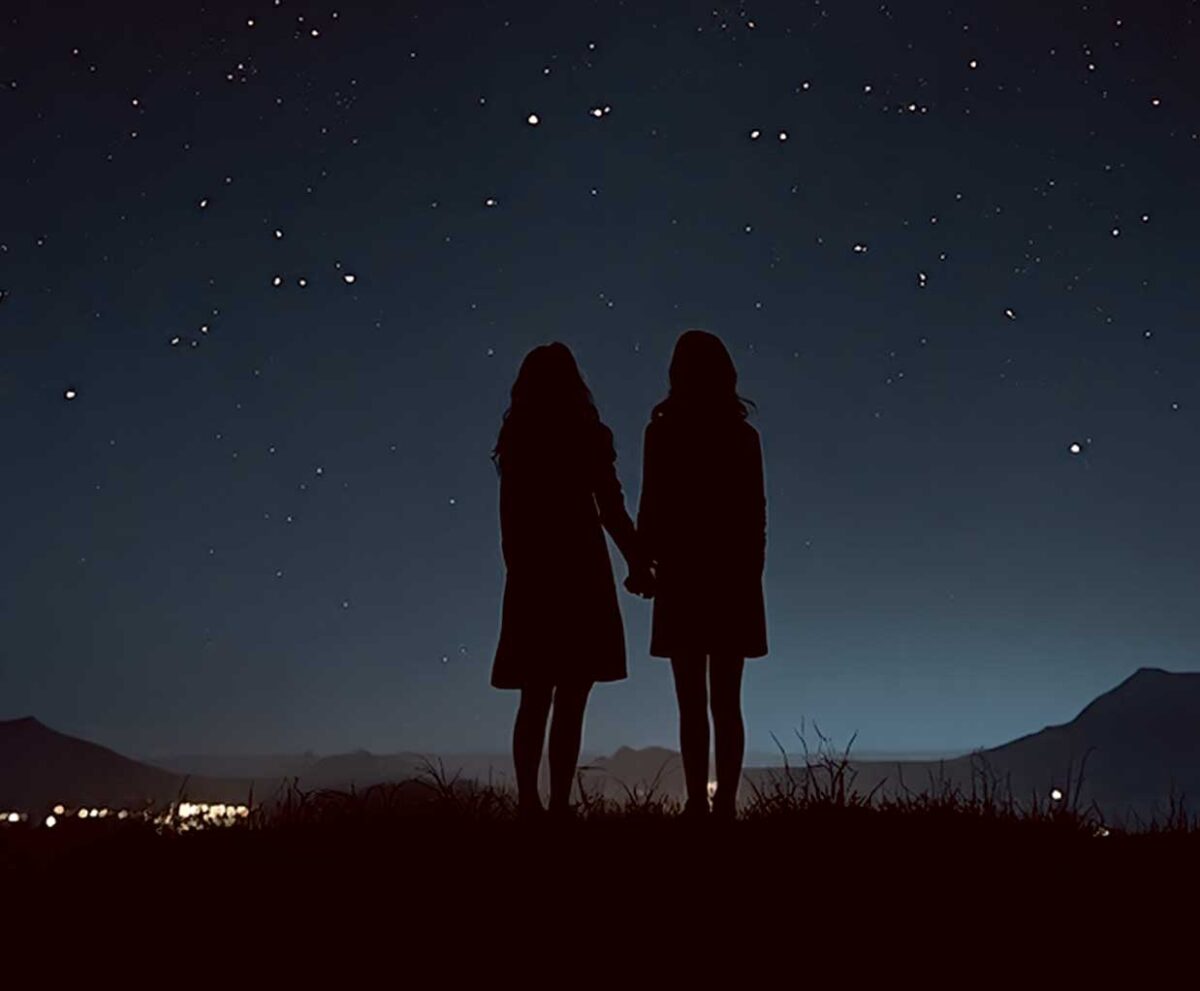Silhouette of a couple holding hands under a starry night sky, displayed in an energy-efficient LED Box Frame with customizable lighting.